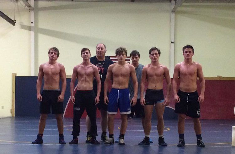 Wrestling team posing in the gym