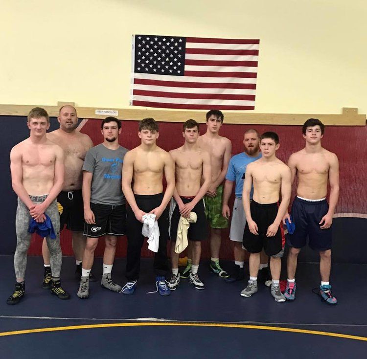 Team of wrestlers standing together indoors