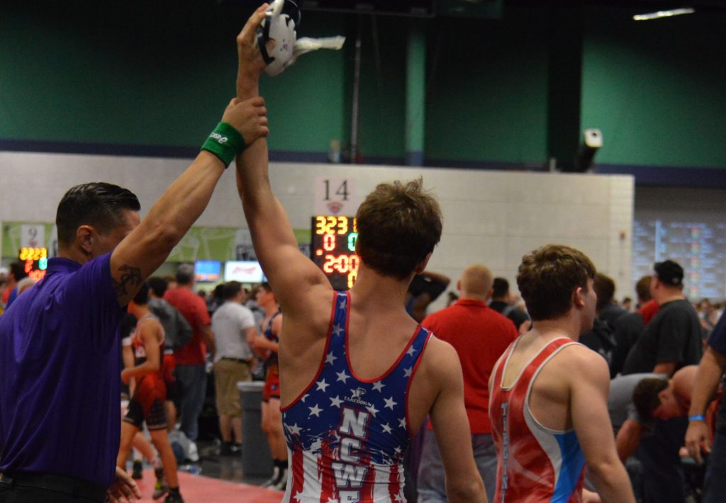 Wrestling match winner announced by referee